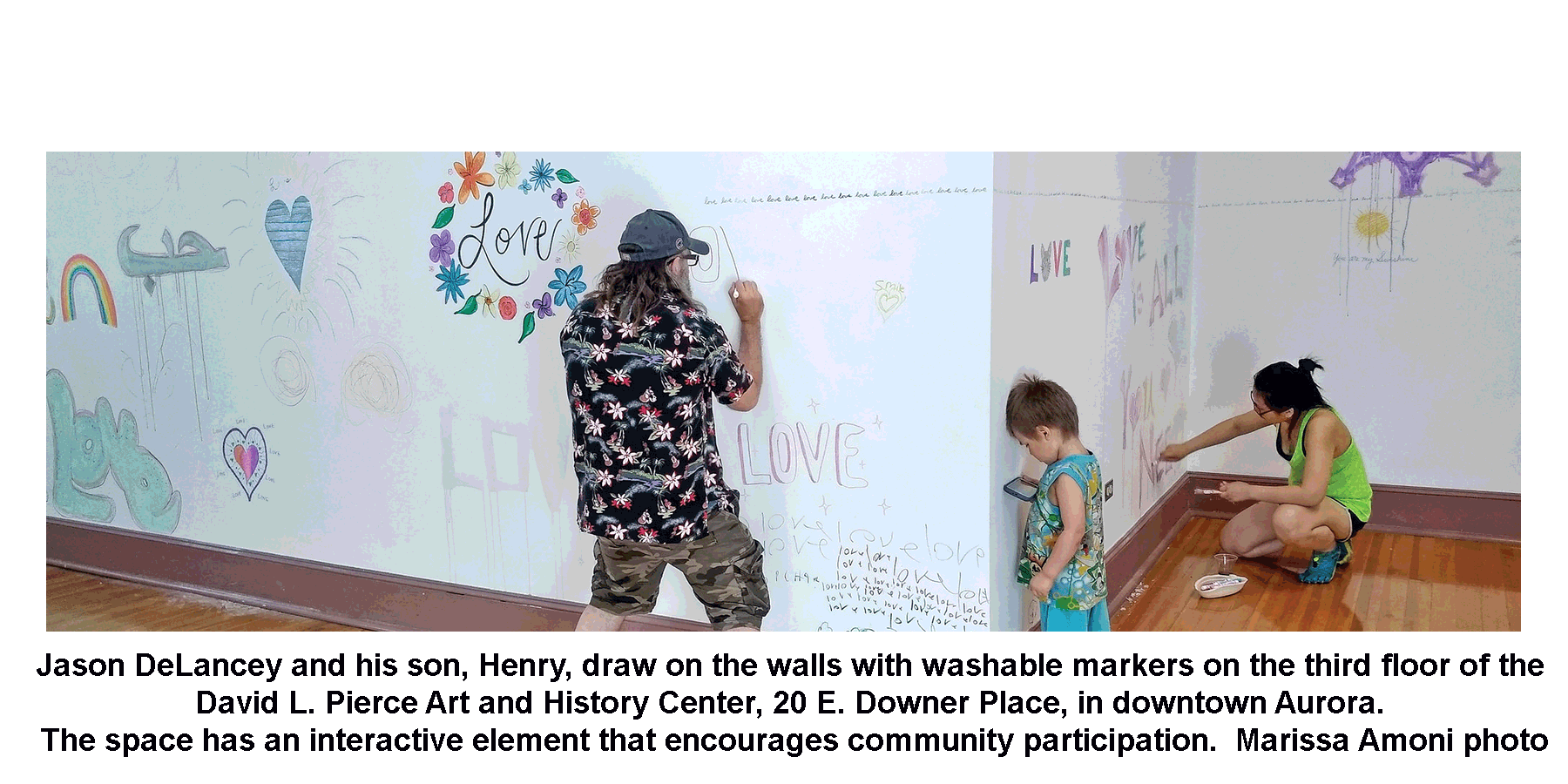 Jason DeLancey and his son, Henry, draw on the walls with washable markers on the third floor of the David L. Pierce Art and History Center, 20 E. Downer Place, in downtown Aurora. The space has an interactive element that encourages community participation. Marissa Amoni photo