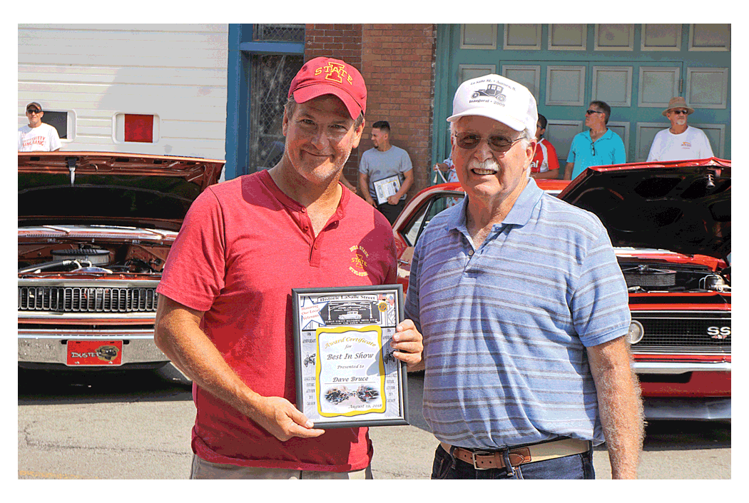 Dave Bruce, Plainfield, holds his certificate for Best of Show at the 10th Annual Historic LaSalle Street Auto Show in Aurora Sunday after receiving the award from show founder Joe Dispensa.
