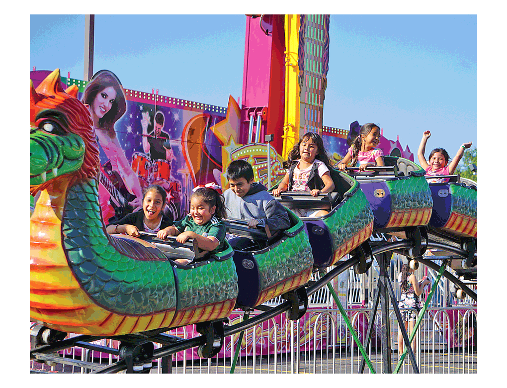 Children express emotions on their dragon ride at the Aurora Fiestas Patrias celebration