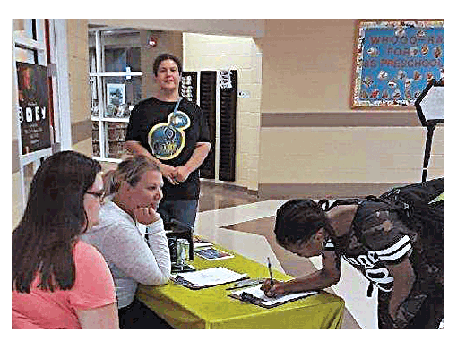 A teen registers for Alive@Eola program at the Aurora Public Library Eola Road Branch. Submitted photos