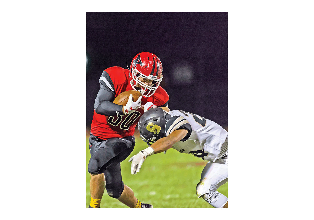 Brandon Lee of Yorkville High School seeks to shed a Sycamore defender in Friday’s Northern Illinois Big 12 East game. Visiting Sycamore won 28-27 in overtime. Steve Groth photo