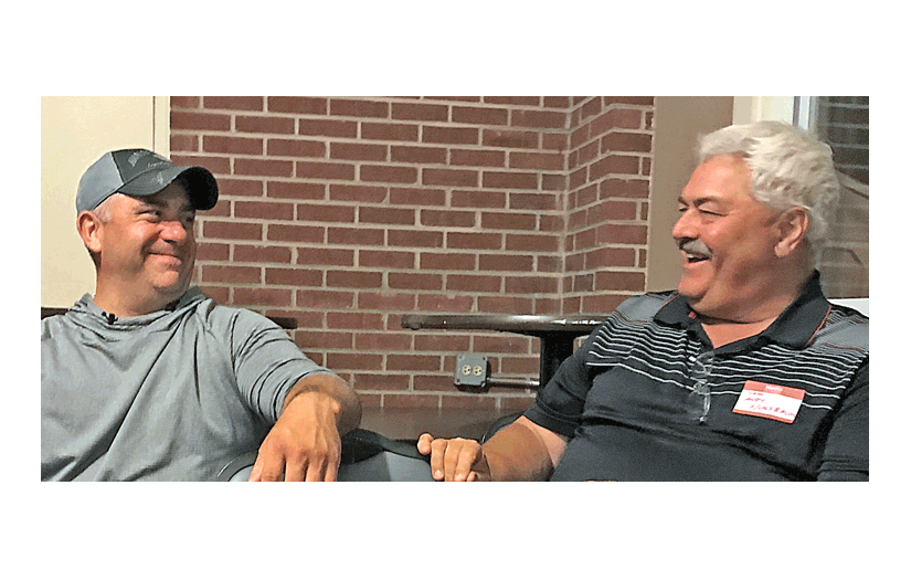 Chris Neal, left, and Andy Nussbaum share a laugh at the Naperville Alumni Night last week. Benny Kenyon photo