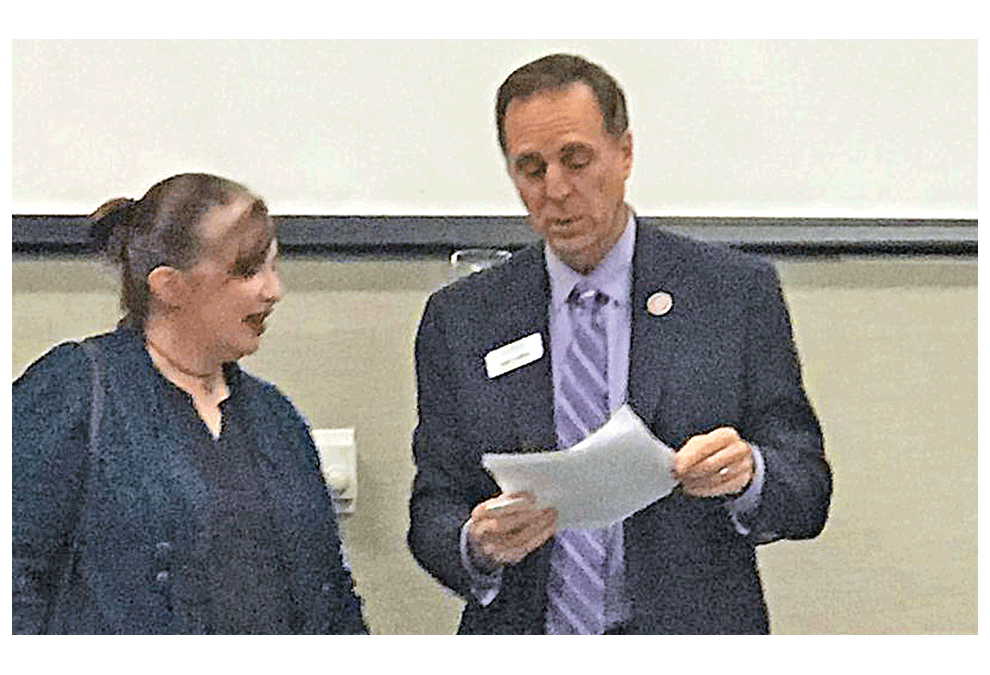 Judd Lofchie confers with Amanda R. Lowe during a recent Aurora Business United group meeting. Submitted photo