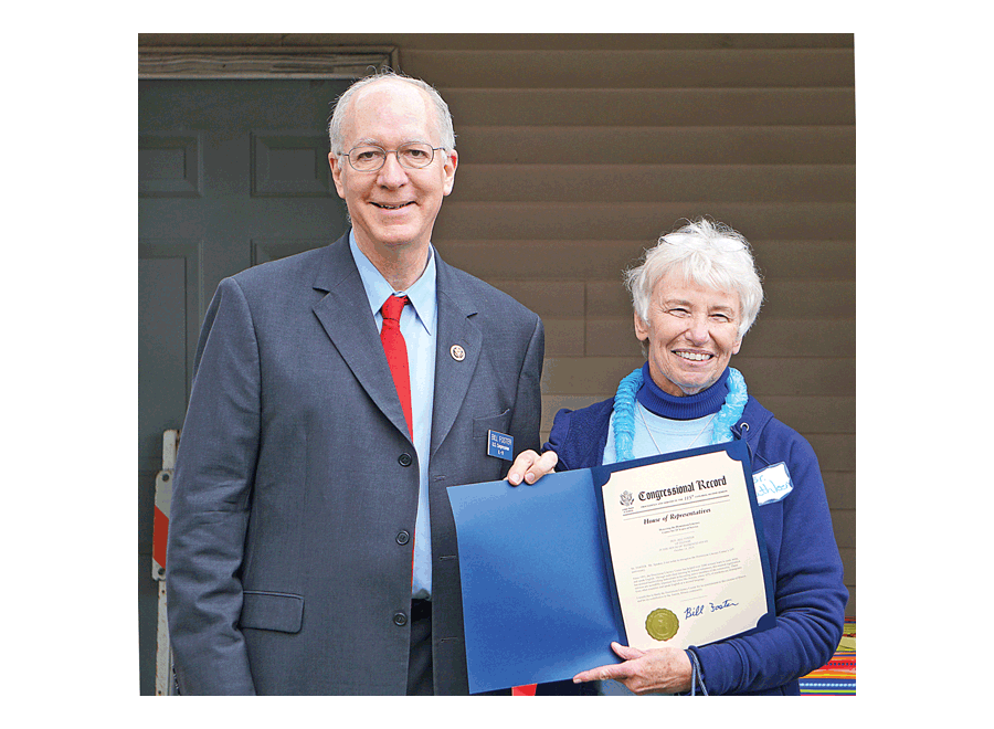 Salute: 25 years of Dominican Literacy Center: Sister Kathleen Ryan of the Dominican Literacy Center in Aurora shows the proclamation in the Congressional Record read Sunday by congressman Bill Foster of the 11th District. The Center celebrates 25 years of service to the Aurora community at St. Therese of Jesus Catholic Church in Aurora. Carter Crane/The Voice