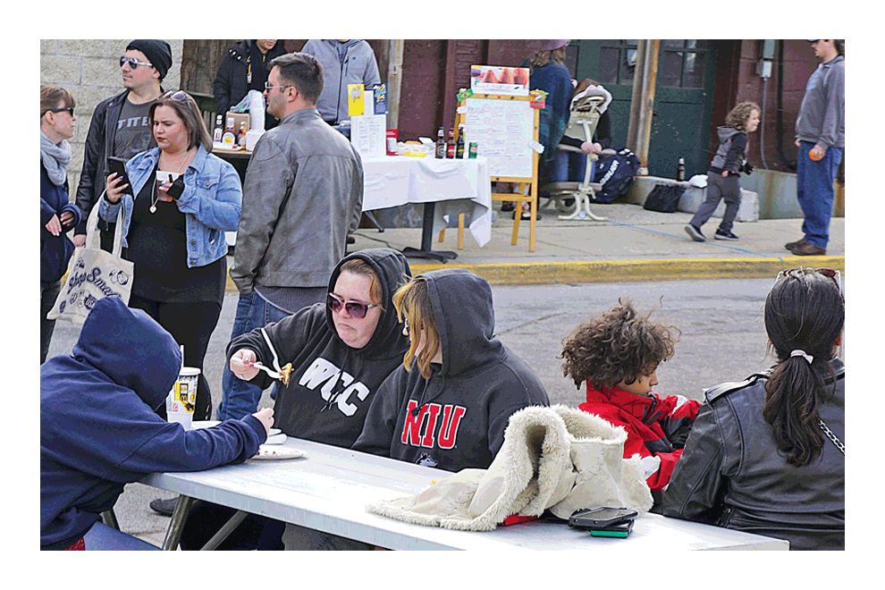 Aurora Octo Street: Chilly air, hooded coats, and food surround the Aurora Octo Street Fest on Pinney Street behind New York Street’s Restaurant Row Saturday. It was the first weekend of cool temperatures. The event was sponsored by Aurora Downtown. Carter Crane/The Voice
