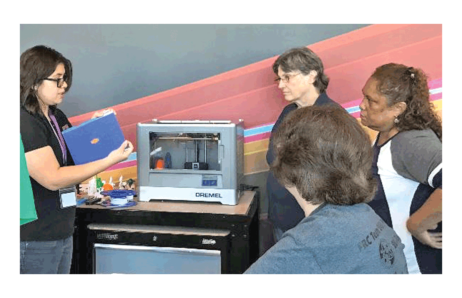 Aurora Public Library digital services assistant manager Giovanna Diaz-Fabiani conducts 3D printer training at the Santori Library. Submitted photo