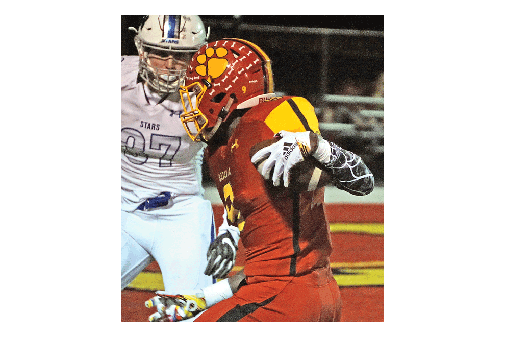 Nick Rempert of Batavia High School on his way to a touchdown moves past Tyler Nubin of St. Charles North in Friday’s first-place showdown game in the DuKane Conference. Batavia won, 27-24, in the waning seconds.  Carter Crane/The Voice