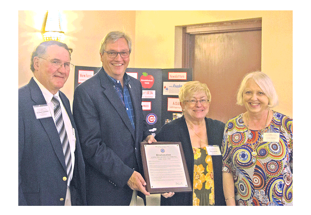 Deputy mayor of Aurora, Chuck Nelson, holds a proclamation Tuesday to honor the Aurora Area Retired Teachers Association (AARTA) on its 60th anniversary