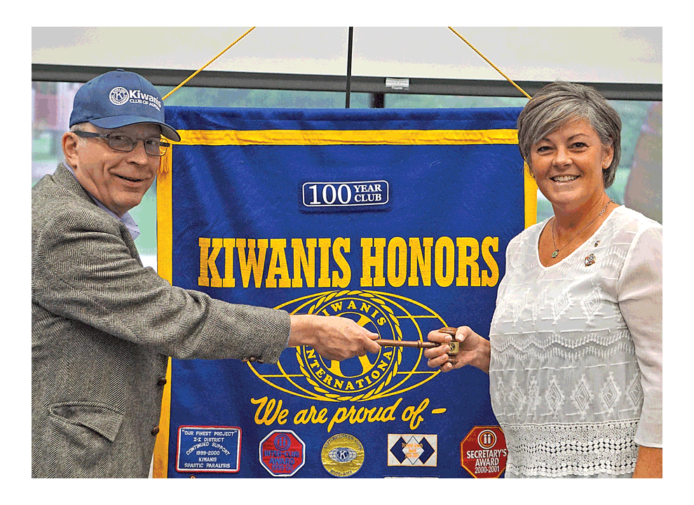 John Ross, left, ends his term as president of the Kiwanis Club of Aurora, by handing a gavel to president Kim Groom at Tuesday’s meeting at the Prisco Center in Aurora. Jason Crane/The Voice