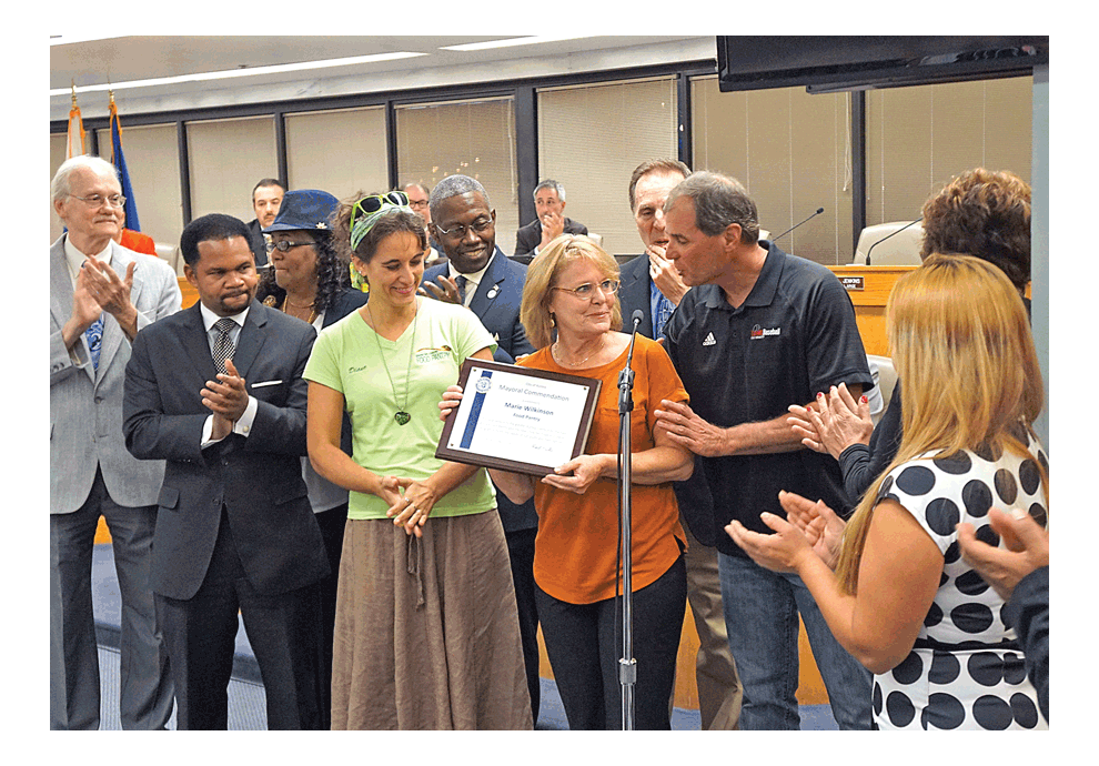A Mayoral Commendation surprises Diane Renner, executive director of the Marie Wilkinson Food Pantry, at the Aurora City Council meeting