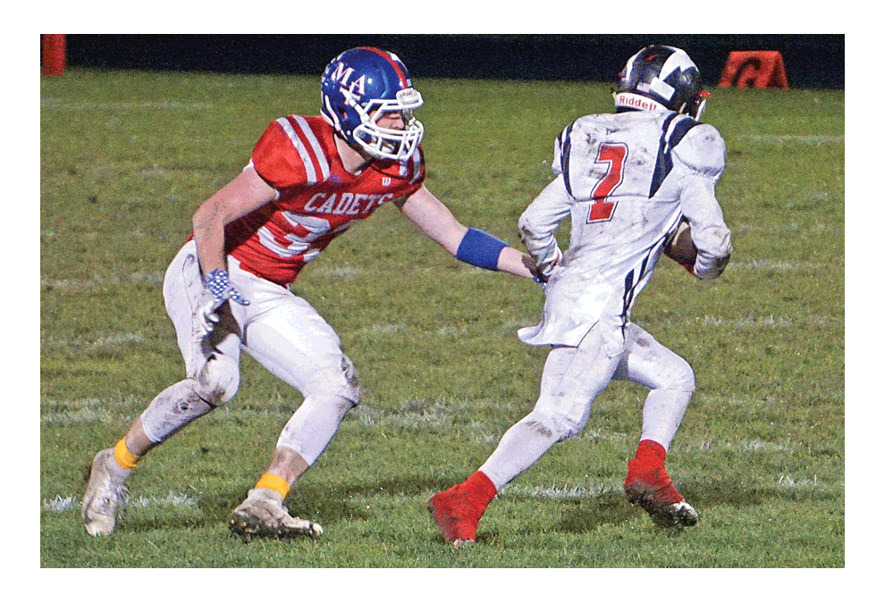 Marmion Academy defender, Ryan McMahon, draws focus on St. Joseph’s Aamir Burgie in the teams’ non-conference game Friday in Aurora. Host Marmion won, 44-14. Marmion, 3-6, will play a first-round Chicago Prep Bowl game Friday at home against Leo. Carter Crane/The Voice