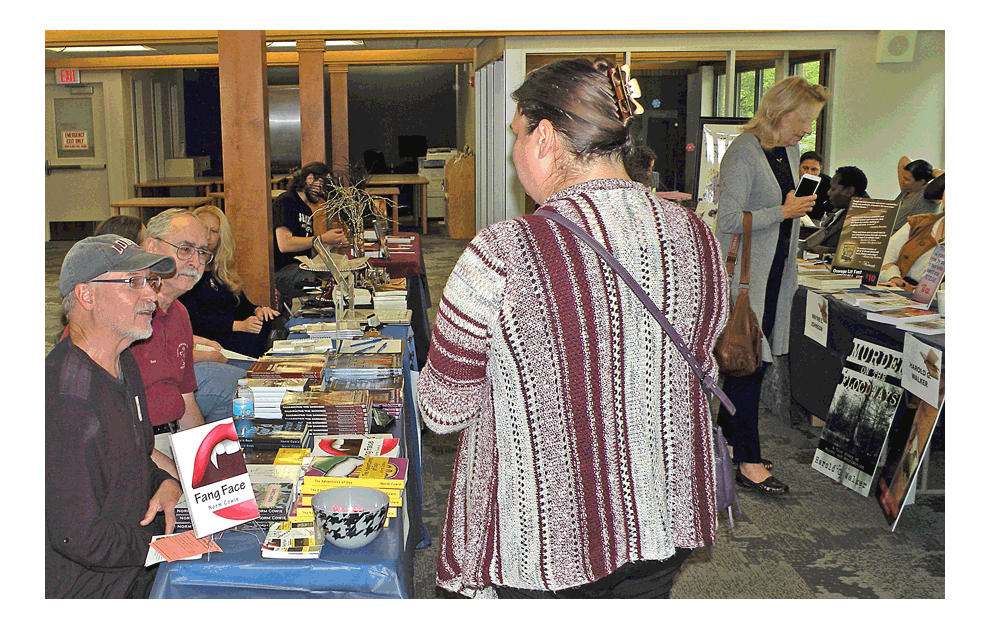 uthors are in position with their books at the seventh annual Oswego Literary Festival Sunday at the Oswego Public Library in Oswego. Approximately 50 authors attended the event. Jason Crane/The Voice