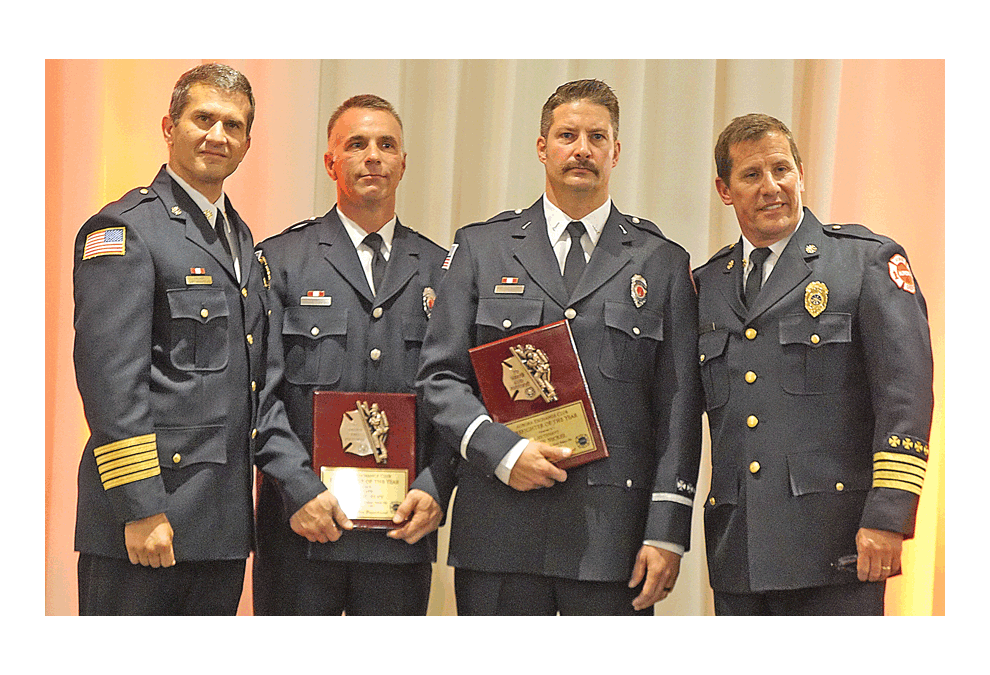 The Exchange Club of Aurora Firefighter of the Year Award: Aurora Fire Department Chief Gary Krienitz, left, presents plaques to firefighter Michael Eley and Lieutenant Kevin Nickel at the Gaslite Manor in Aurora Tuesday. They were honorees with firefighter/paramedic Jacob Erdmanis (not in photo). In October 2017, the members of the Water Rescue Team heroically saved the life of a six-year-old child from a submerged vehicle in a pond. Deputy Fire Chief John Gilbert is on the right. Jason Crane/The Voice