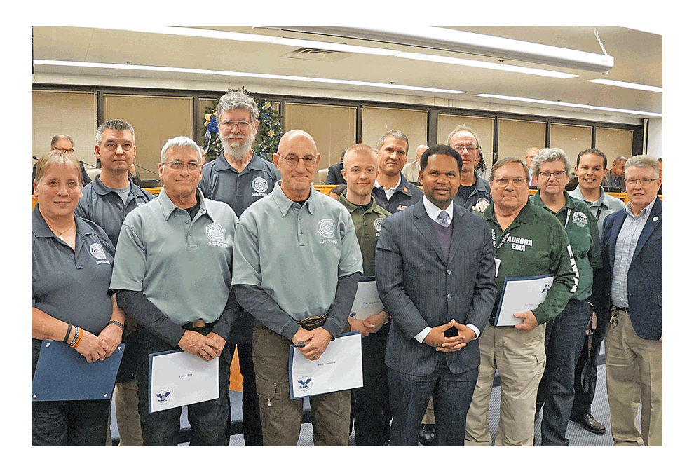 Emergency Management Agency members in Aurora pose with Richard C. Irvin, mayor of Aurora at Tuesday’s City Council. Jason Crane/The Voice