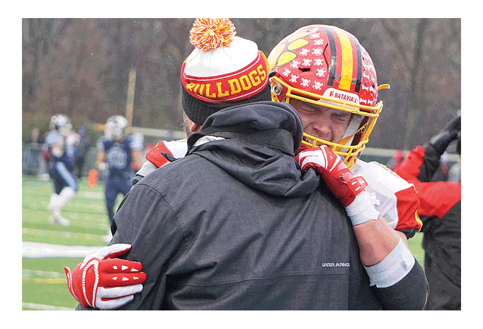 Season is over: Batavia High School’s Luke Weerts sheds tears in an embrace with head coach Dennis Piron following Saturday’s playoff defeat. Carter Crane/The Voice