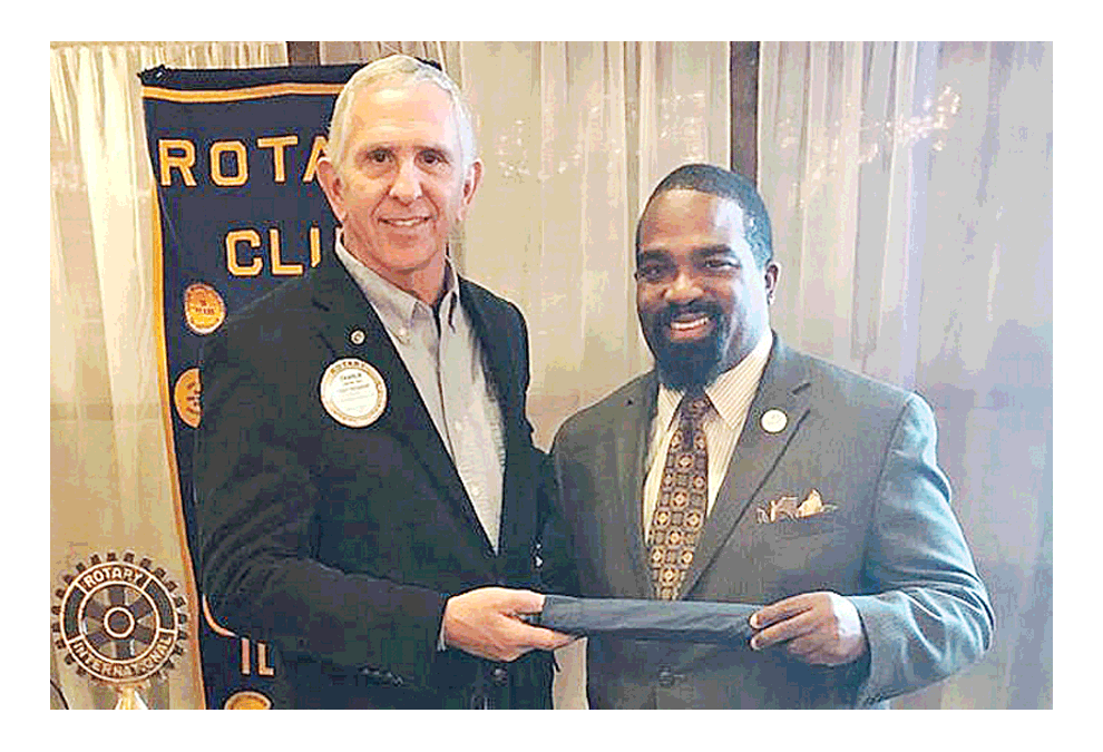 Charlie Zine, president of Rotary Club of Aurora presents a Rotary umbrella to Keith Gerald from OnLight Aurora