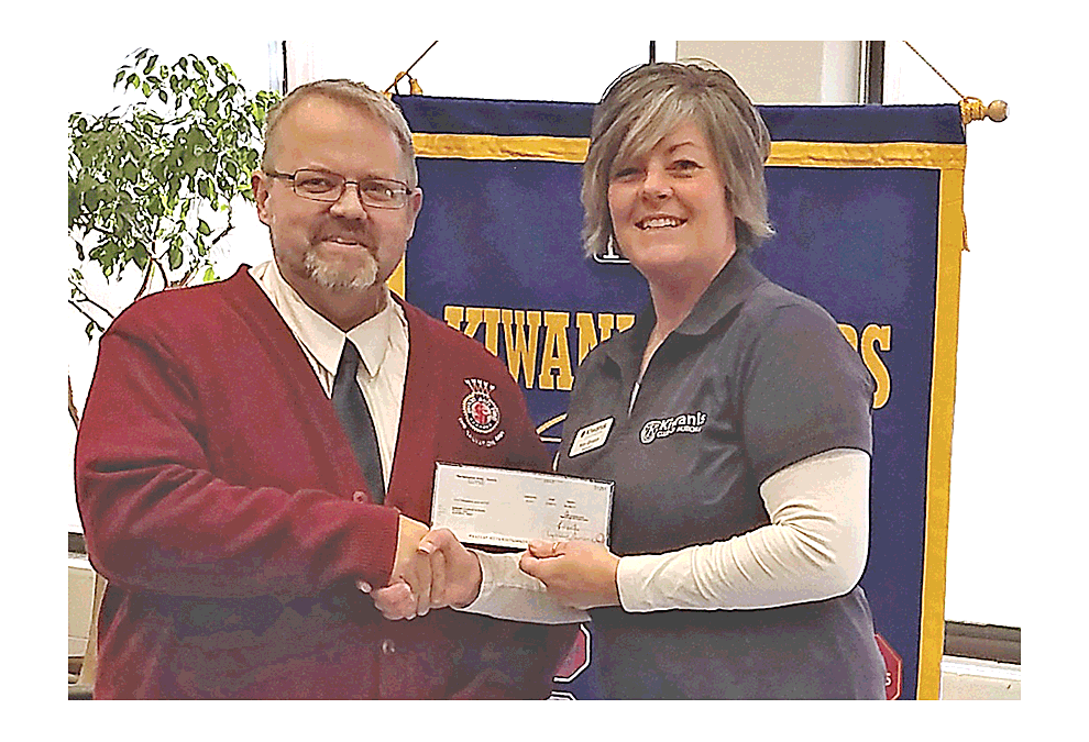 Captain Rich Forney of the Salvation Army of Aurora presents the Kiwanis Club of Aurora with $5,000 to help with Coats for Kids at a recent Kiwanis Club meeting. Submitted photo