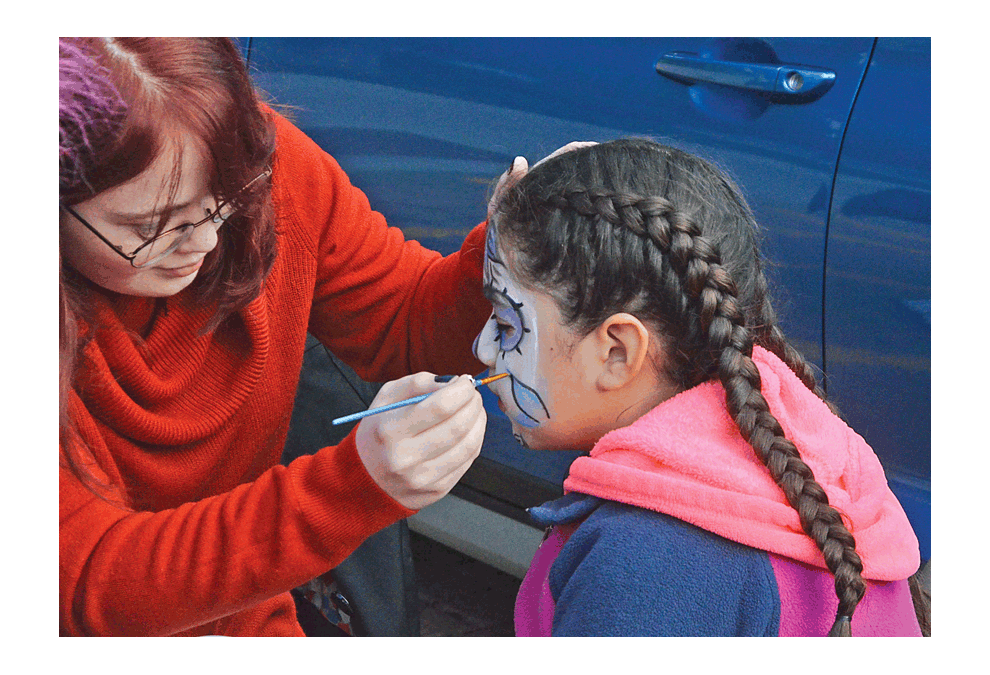 Face-painting was among activities offered by Lions Club members at Waubonsee Community College's Halloween Trunk-Or-Treat Saturday, Oct. 27. Families were invited to attend the free event in the parking lot at the school's downtown Aurora campus. The celebration included free games, swag bags, and treats, dispensed from decorated vehicle trunks. Al Benson/The Voice