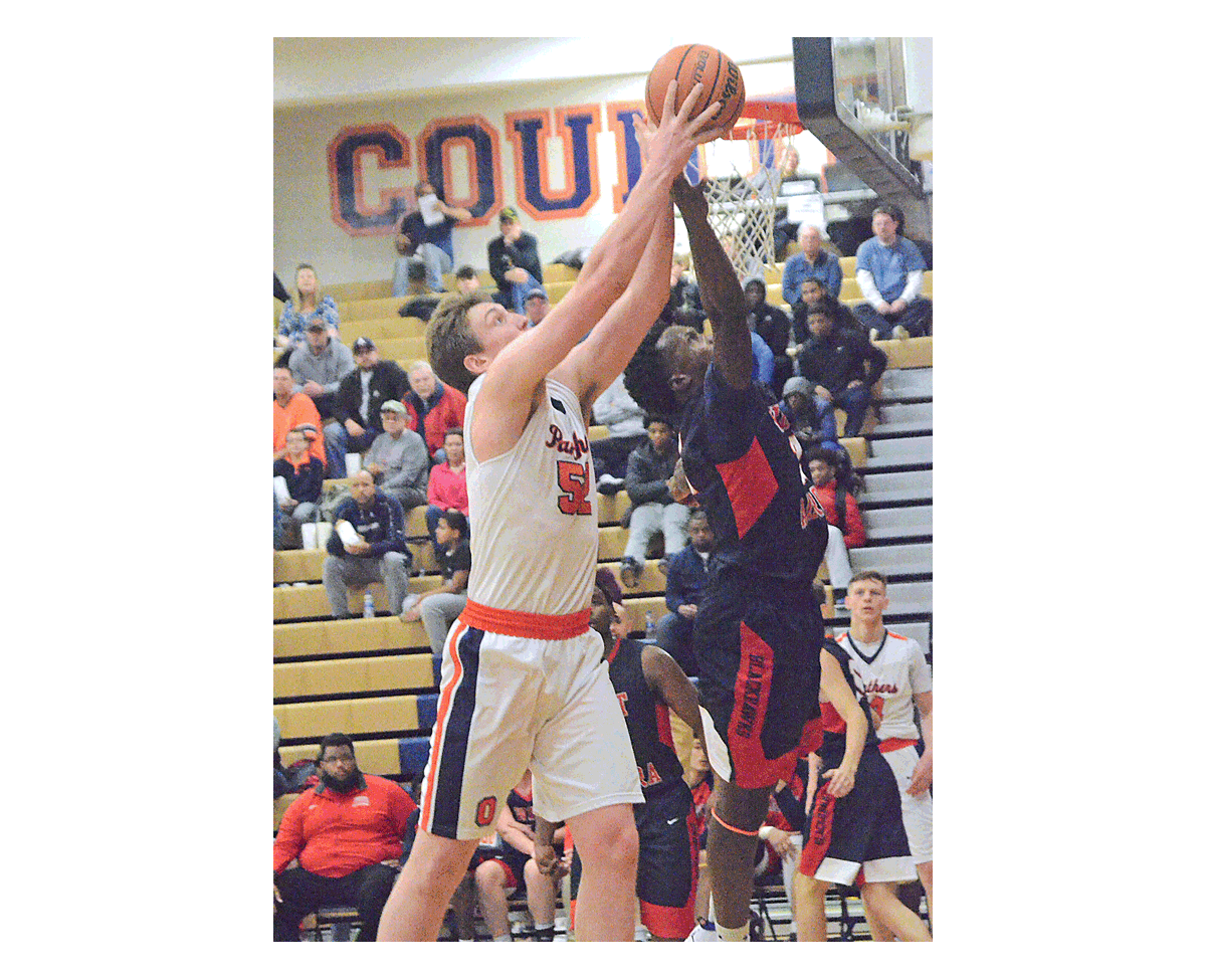 Oswego High School's Connor McCance, left, and West Aurora's Hezekiah Salter compete for a rebound at Oswego's Hoops for Healing Tournament. West Aurora won, 69-66, Wednesday, Nov. 21. Oswego East defeated West Aurora in the championship game Friday. Al Benson/The Voice
