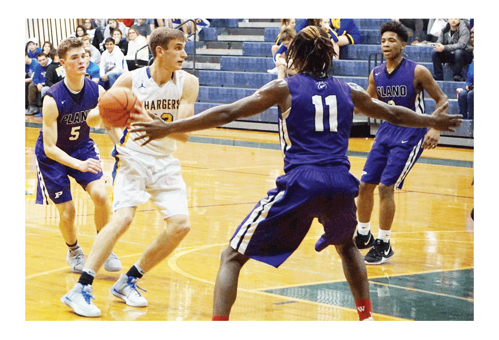 Jonas Cebulski, a 6-3 guard for Aurora Central Catholic, finds Plano High School defenders in his way Tuesday, Dec. 18 in a non-conference basketball game. Visiting Plano won, 64-46, after trailing, 32-22, with 1:11 remaining until halftime. Bryson Schmidt, 5, and Ka’Jon Smith, 11, play defense for Plano. Jason Crane/The Voice