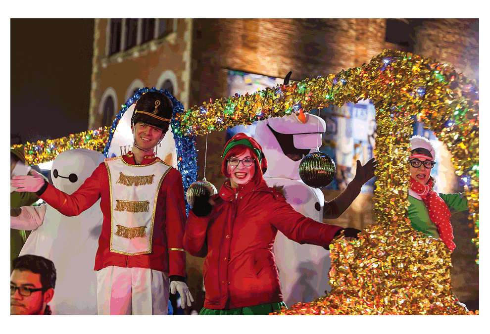 Gina Salamone waves, along with Derek Conley, on an Aurora Downtown float in last year's Winter Lights parade. Salamone is a volunteer board member for Aurora Downtown, a nonprofit of business and property owners in SSA #One in Aurora. Jason Arthur photo