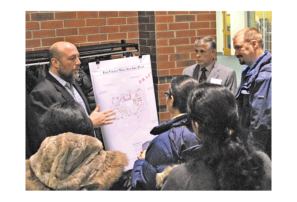 Trevor Dick, left, director of Development Strategy and Facilitation for the city of Aurora answers questions at the City of Aurora’s DRAFT Route 59 Comprehensive Plan Update open house, Thursday, Dec. 6. The event included development renderings for information, discussion, and public input. Some objectives for the Fox Valley Mall are: • To encourage new multi-family housing and mixed-use developments in and around the Fox Valley Mall property. • New housing encouraged at strategic locations within easy access of transit and commercial uses. • Support infill and redevelopment of underperforming properties. The plan can be seen at the city government of Aurora’s website. Jason Crane/The Voice