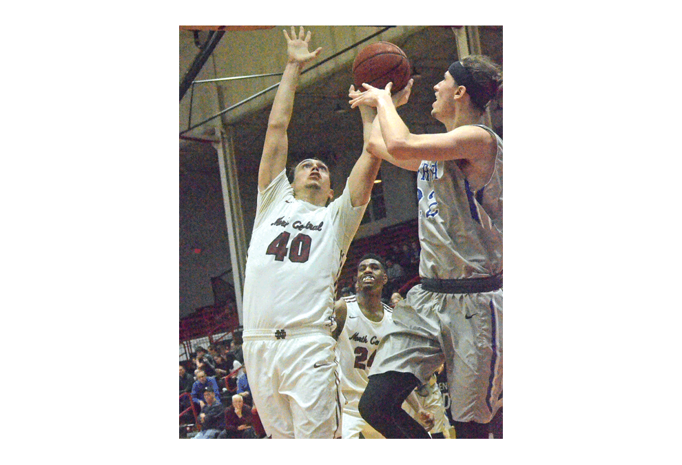 Aurora University’s Justin Wierzgac shoots over North Central College’s Will Clausel, formerly of Newark High School, last week. Host North Central won, 73-63. Al Benson/The Voice