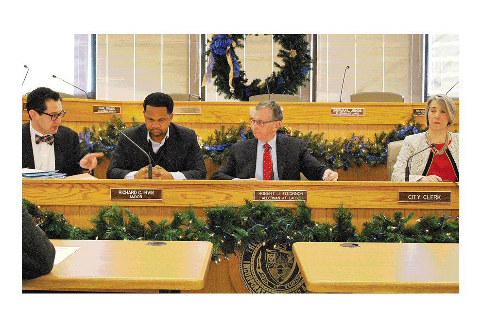 Ross D. Secler, left, Chicago election law and campaign finance attorney, advises the city of Aurora Municipal Officers Electoral Board at one of five hearings for aldermanic candidates in Aurora at City Hall, Wednesday, Dec. 19. Board members are: Mayor of Aurora, Richard Irvin, Aurora alderman-at-large, Robert O’Connor, and Wendy McCambridge, city clerk. Candidate for 1st Ward, Peter Aguilera, was the only one of five who had objections overruled. Candidates were denied for several reasons regarding rules of filing nomination papers correctly. Nomination papers were denied due to failure to fasten them as required. The aldermanic candidates who were denied for incorrect filing of nomination papers: Hugo Saltijeral, candidate for 1st Ward; Valerie Budach, candidate for 1st Ward; John Robinson, candidate 8th Ward; and Paul J. Santucci, candidate for 1st Ward. All races for Aurora aldermen have fewer than five candidates each, therefore, a primary in February 2019 will not be held. Jason Crane/The Voice