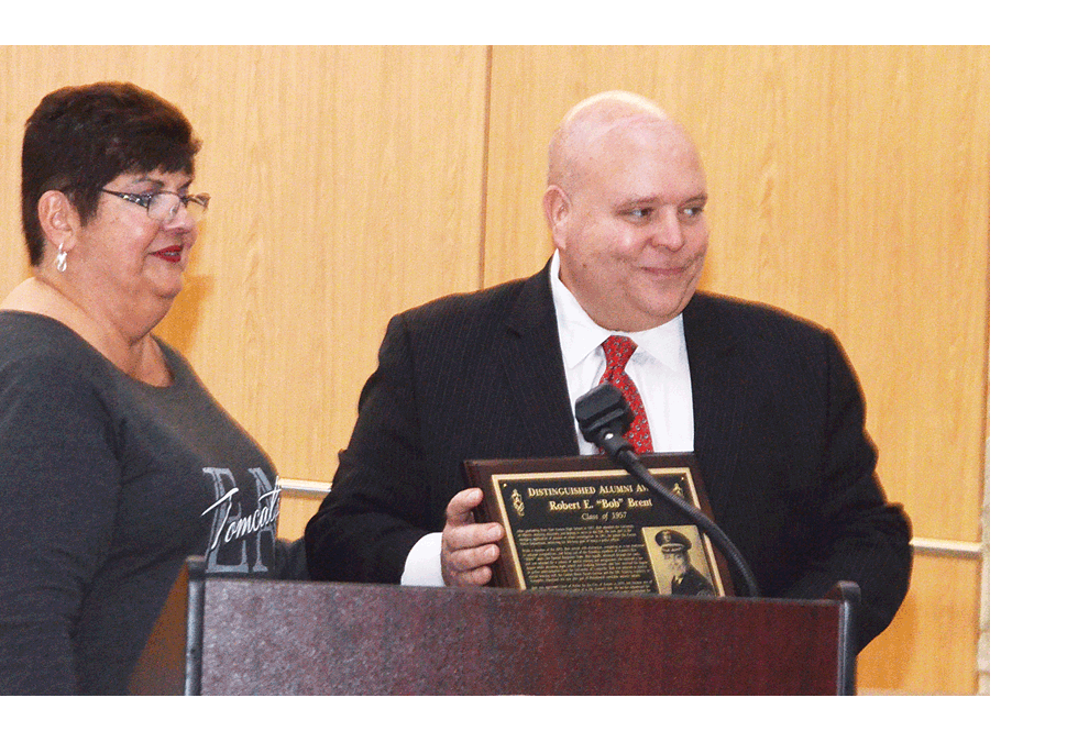 Mark Brent, right, son of the late Bob Brent, accepts his father’s East Aurora High School Distinguished Alumni Award from Blanca Souders, East Aurora Alumni Association, Friday, at the honor at East Aurora. Bob Brent was the police chief in Aurora for 12 years, starting in 1979. He joined the Aurora Police Department in 1961. He was graduated from East Aurora in 1957. He established the Aurora police cadet program and instituted 911 service and call center in Aurora. He served on numerous social and civic organizations in retirement. Al Benson/The Voice
