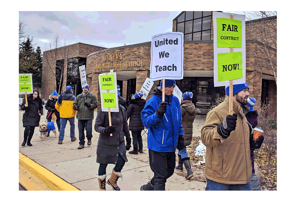 Geneva teachers walk: Teachers from Geneva School District 304 hold telling signs Tuesday on the first day of a strike following prolonged negotiations. The teachers worked without a contract. Their walk was in front of Geneva High School in shifts. Dustin Krueger/The Voice