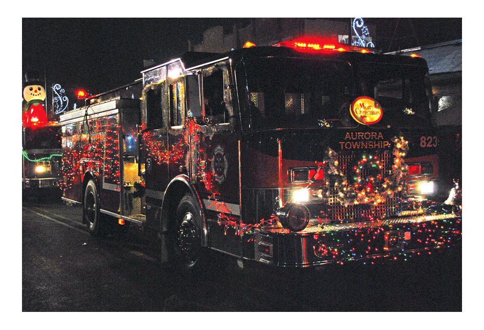 An Aurora Township Fire Department truck participates in the annual Oswego Illuminated Silent Parade at the Oswego 2018 Christmas Walk downtown Friday. The silent parade and Christmas tree lighting drew a huge crowd on a clear evening. The Oswego Fire Protection District sponsored the parade.