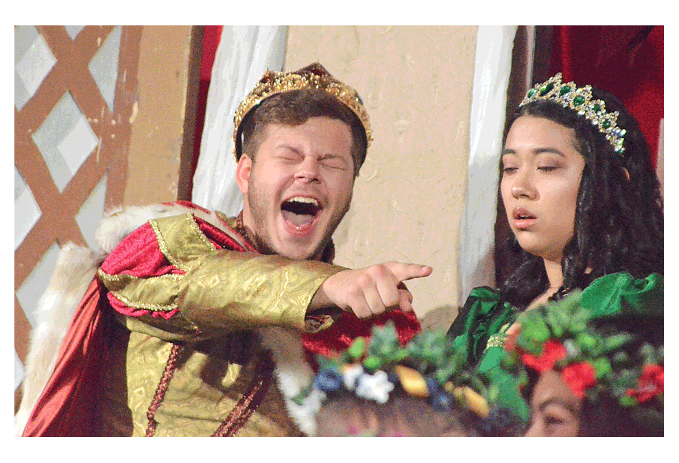 King David Capp laughs in the presence of Queen Amanda Duran at the 32nd annual madrigal dinner Saturday, Dec. 15, at West Aurora High School. In addition to an opening procession, the event included toasts, a feast, a masque (play) and music by madrigal singers, Lyric Chorus, 36 singing wenches and madrigal brass. West Aurora culinary arts students prepared the feast. Al Benson/The Voice