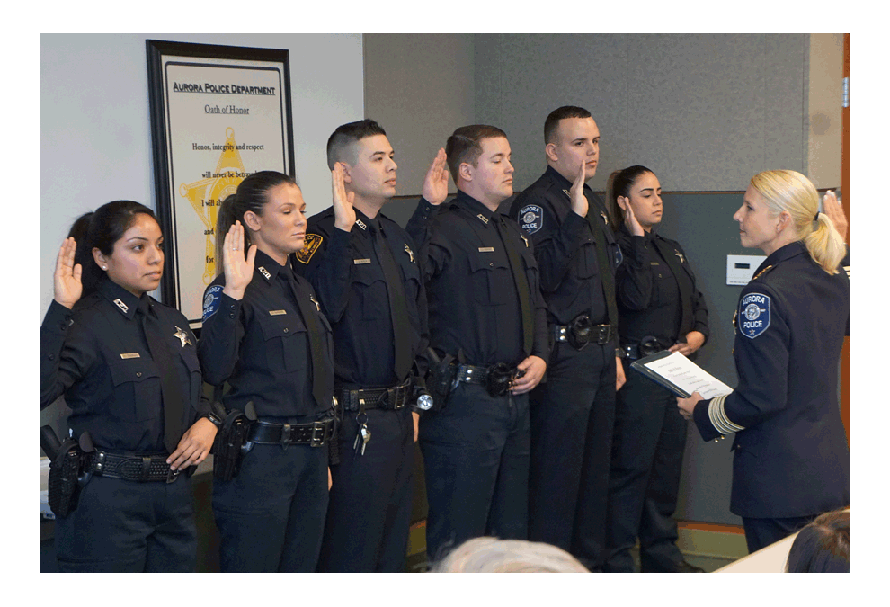 Aurora Police Chief Kristen L. Ziman administers the Oath of Office to Aurora Police recruits