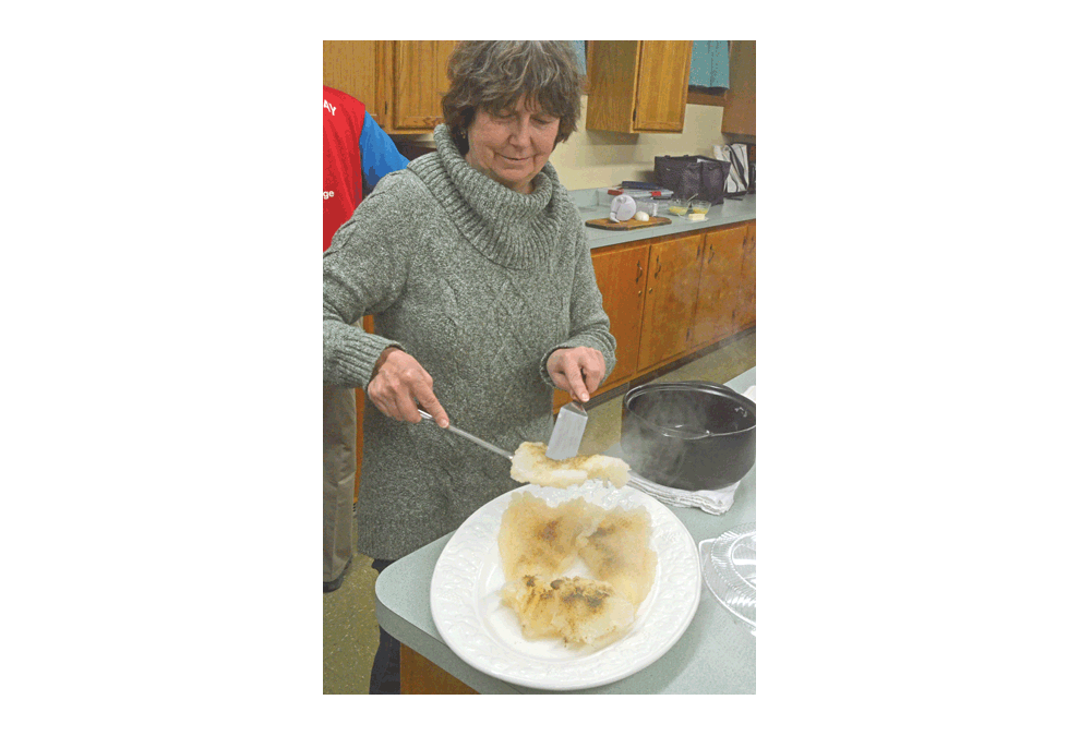 Barb Brungart of Aurora prepares lutefisk during a recent cooking class at St. Olaf Lutheran Church in Montgomery. The class was at the monthly meeting of Sons of Norway Polar Star Lodge 5-472, a Norwegian-American social group. Al Benson/The Voice