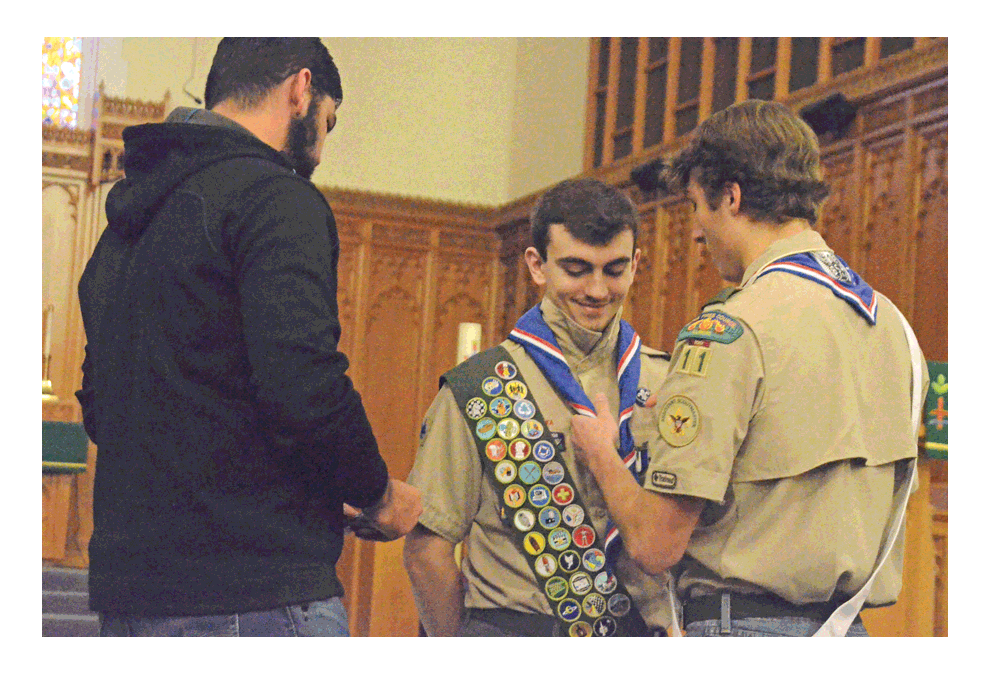 Cole Butler of North Aurora receives his Eagle Scout neckerchief from Blackhawk Troop 11 Eagle Scouts Harris Shafi, left, and Justin Huberty, right, Saturday, Jan. 19 at Wesley United Methodist Church in Aurora. Butler, 17, of North Aurora, was awarded the highest rank attainable in the program of the Boy Scouts of America. He was honored in a traditional court of honor held by Blackhawk Troop 11, Three Fires Council, at Wesley UMC. Troop 11, the second oldest in Illinois, was founded in 1916 at Galena Episcopal Methodist Church, predecessor of Wesley UMC. Butler is a senior honors student at West Aurora High School. He plans to attend Illinois State University in the Fall. Al Benson/The Voice
