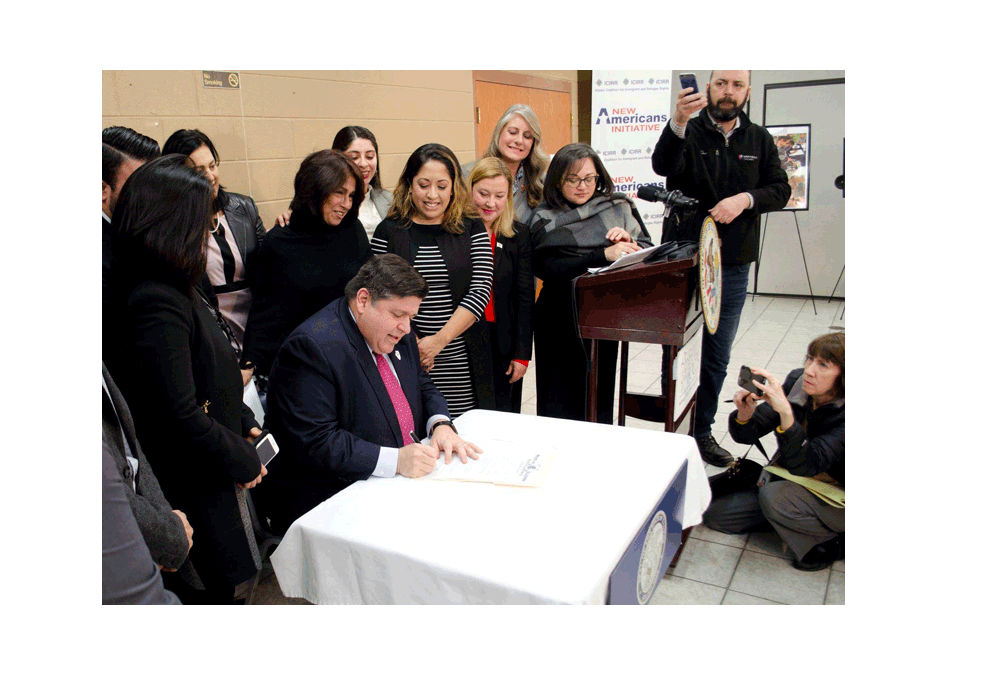 Governor-JB-Pritzker-of-Illinois-signs-an-executive-order-January-24-at-Family-Focus-social-agency-in-Aurora-to-require-immigrants-to-have-access-to-welcoming-centers-with-support-programs