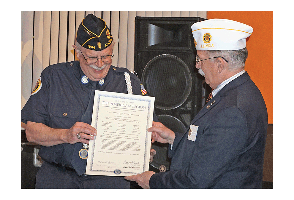 Chuck Granholm, left, receives a charter to begin the Walter E. Truemper Legion Post 1944 from Michael Calder, American Legion Department of Illinois. The presentation was Thursday, Feb. 7 at the new home of Post 1944, the Warehouse Church in Aurora. There are 25 members now. Granholm is commander, Gary Krolik is senior vice commander, John Sbarbaro is adjutant, and Fred Torres is chaplain. The next meeting will be at 7 p.m. February 20 on the 75th anniversary of the death of Walter E. Truemper of Aurora in World War II. Carter Crane/The Voice