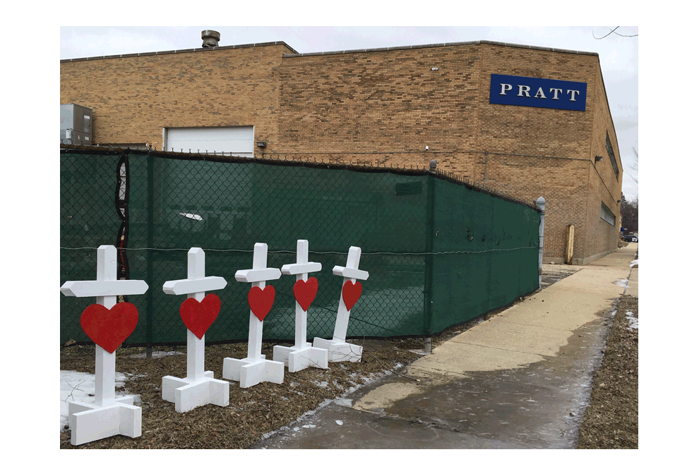 Crosses outside the Henry Pratt Company in Aurora where a shooting occured February 15