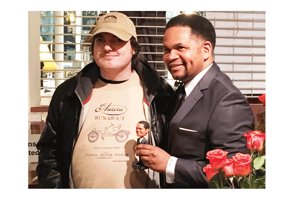 Historical mayor autographs his bobblehead: Mayor of Aurora, Richard Irvin, poses with Andrew Hamilton from Aurora with an autographed bobblehead Friday. The Aurora Historical Society gift shop at the Pierce Art and History Center, was open as a participant of Downtown Aurora’s First Friday, Feb. 1. Irvin made history in 2017 when he was elected as the City’s first African American mayor. The bobblehead sells for $30 plus tax in time for African American History Month. The Aurora Historical Society features a photo exhibit to celebrate the 170th anniversary of the Burlington Northern Railroad in Aurora. Jason Crane/The Voice