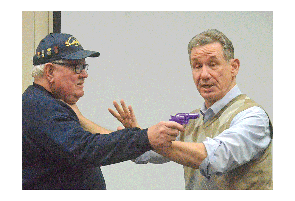 Oswego resident Herschel Luckinbill, above, left, portrays a gunman being disabled by self-defense expert Joe Rosner of McHenry County. Rosner spoke and demonstrated self-defense tactics in "How to Protect Yourself if Attacked" at Aurora Navy League Council 247's monthly dinner meeting at Grandma's Table Restaurant in Montgomery Tuesday, Jan. 15
