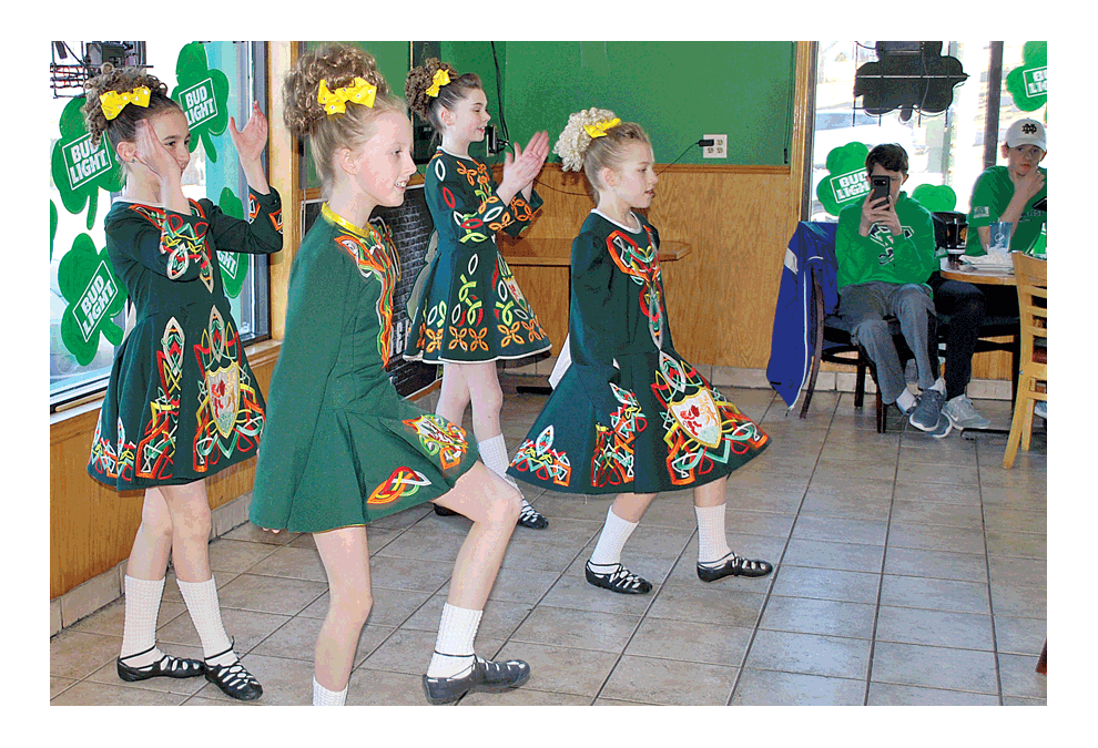 Dancing the Irish way: McNulty Irish Dancers entertain patrons at O’Malley’s Pub and Eatery in Aurora as part of their St. Patrick’s Day Celebration. A video can be seen at facebook.com/thevoice.us. Jason Crane/The Voice