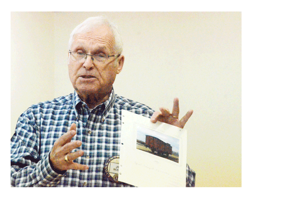 Aurora resident Jim Scott shows a photo at the Aurora Noon Lions Club meeting Monday of the late 1930s/1940s Auschwitz Nazi concentration camp in Poland. He was on a guided tour of Auschwitz and Birkenau camps during a December 2018 European vacation. Al Benson/The Voice