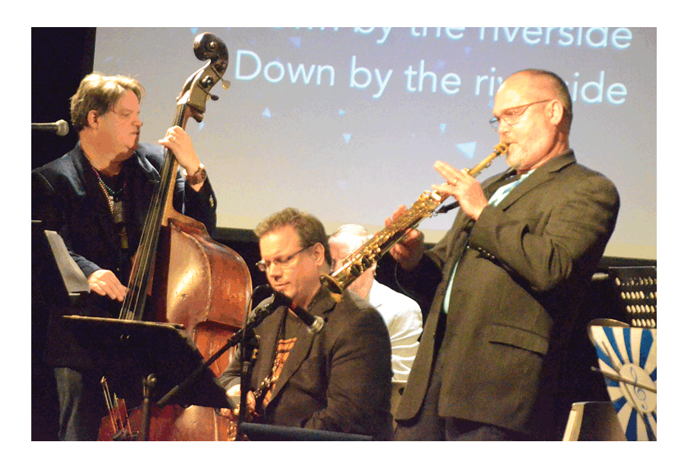 Matt Erion of Aurora, left, Glen West, Geneva; and Jeff Ford, Oswego, swing out on “Down by the Riverside” at Flowing Forth United Methodist Church’s Fat Tuesday jazz concert at Aurora Christian School. The third annual Mardi Gras-style jazz concert by Erion’s Dodeca Band was free to the public. UMC Northern Illinois Conference Aurora District superintendent, Jeff Bross, was solo on “Amazing Grace”. Al Benson/The Voice