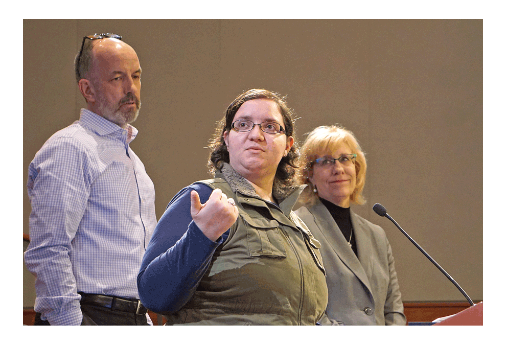 Klaudia Stamatakis, center, answers questions about her proposed dog daycare facility at the Montgomery Village Board meeting Monday. She is proposing to build a 2,000-square-foot facility for Wooforia, LLC in the 2000 block of Mayfield Drive near Route 30 and Orchard Road. She seeks approval of a special use that would allow development of a dog daycare facility with an outdoor component for the dogs. Discussion will continue in the April 8 meeting. Jason Crane/The Voice