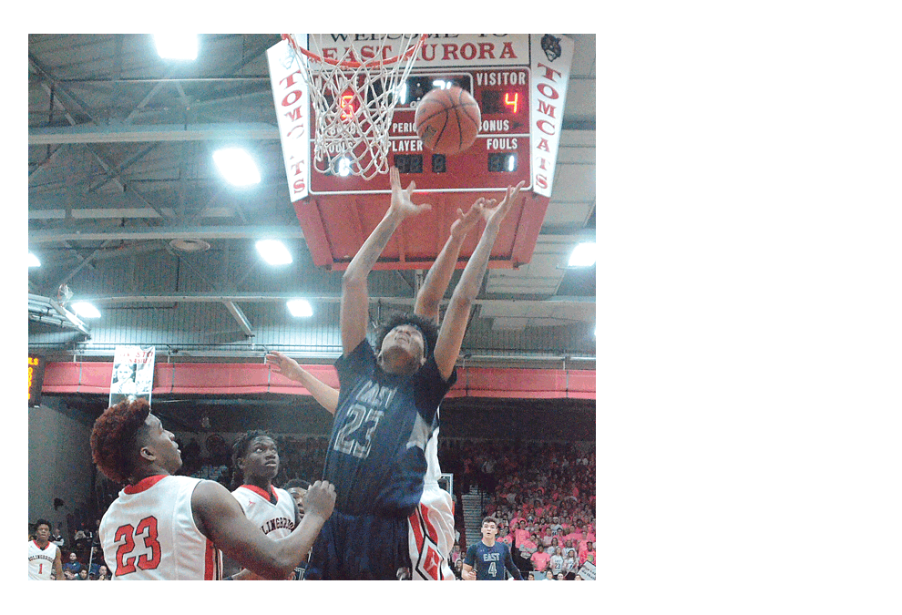 Oswego East High School’s Kamron Battle, 23, rebounds against Bolingbrook defenders in the Class 4A sectional championship at East Aurora Friday. Bolingbrook won, 66-64. Al Benson/The Voice