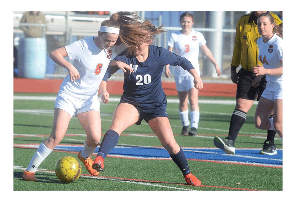 Oswego High School's Sarah Petrauskas, 6, and West Aurora's Gracie Prather, 20, compete for control of a loose ball at West Aurora Friday, March 22. West Aurora won in the non-conference match, 1-0. Al Benson/The Voice