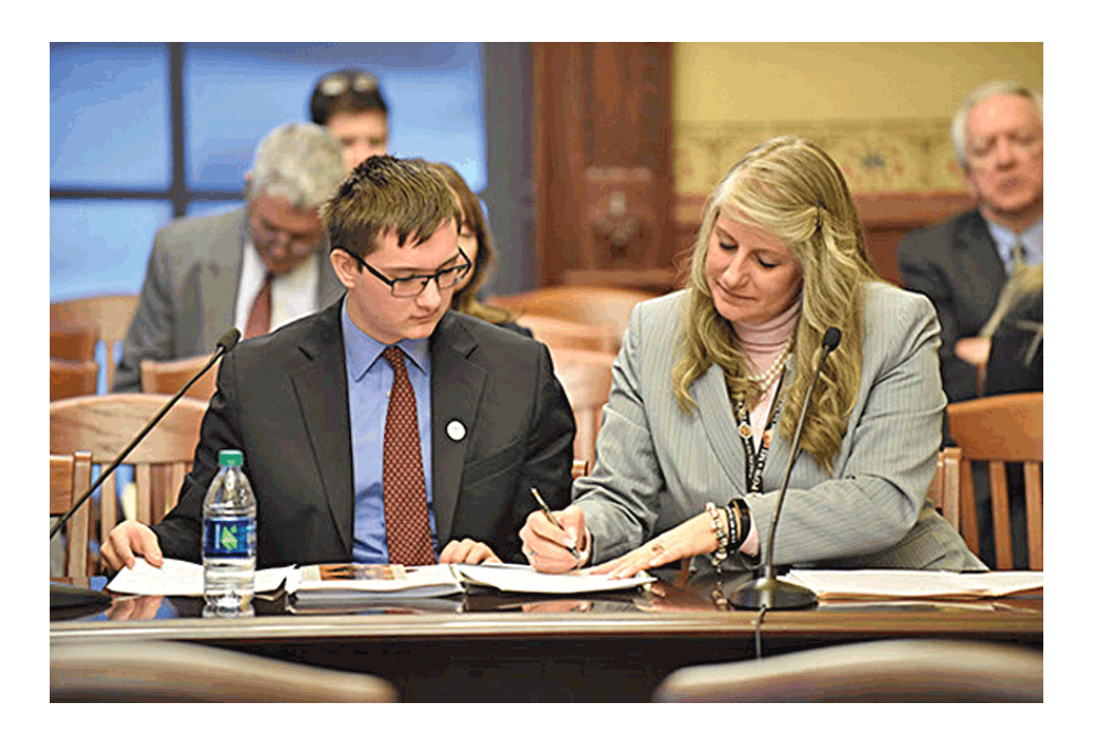 State representative Stephanie Kifowit, D-Oswego, and Adam Pauley from her Youth Advisory Council focus on House Bill 837 in the State Government Administration Committee. Submitted photo
