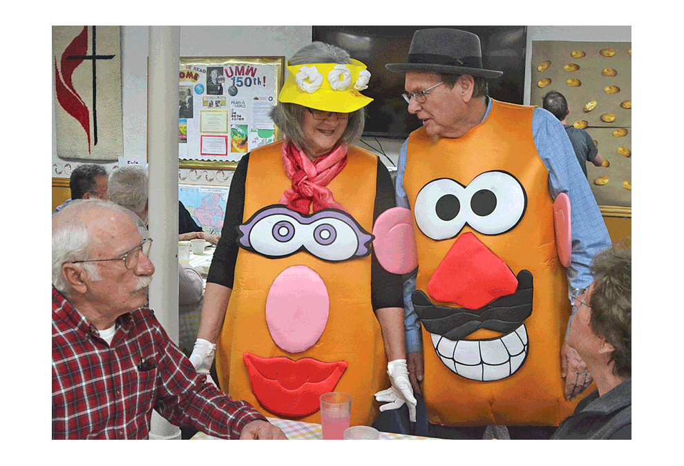Oswego residents Judy and Jim McGregor portray Mr. and Mrs. Potato Head and greet guests Sunday at Oswego's Church of the Good Shepherd United Methodist. An ultimate baked-potato bar raised funds to benefit a first potato drop of 42,000 pounds of Wisconsin potatoes in the church parking lot May 4 for Aurora area food pantries. Al Benson/The Voice