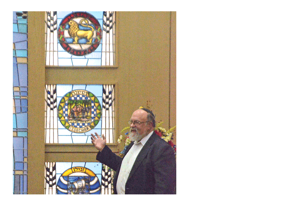 Rabbi Edward Friedman gives remarks in front of windows representing the 12 tribes of Israel during a “Meet Your Jewish Neighbor” program Sunday at Temple B’nai Israel in Aurora. Al Benson/The Voice