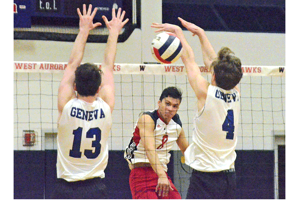 West Aurora High School's Erik Perez, 8, hits against Geneva defenders in the 12-team Blackhawk boys varsity invitational Saturday. West Aurora defeated Geneva in a second-round match and went on to defeat Wheeling in the championship Gold Division match, 16-25, 25-22, 25-18. Al Benson/The Voice